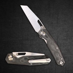 Two folding knives on a dark textured background, one open to show a sharp blade and the other closed with a pocket clip visible.