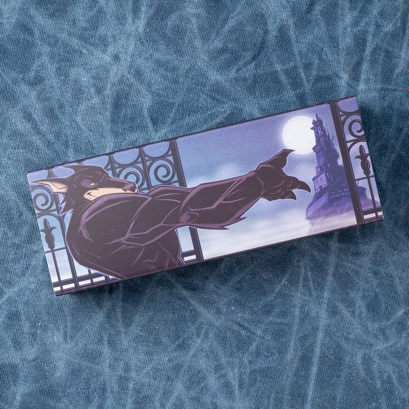Batman silhouette reaching through an ornate gate toward a moonlit castle on a rectangular card.